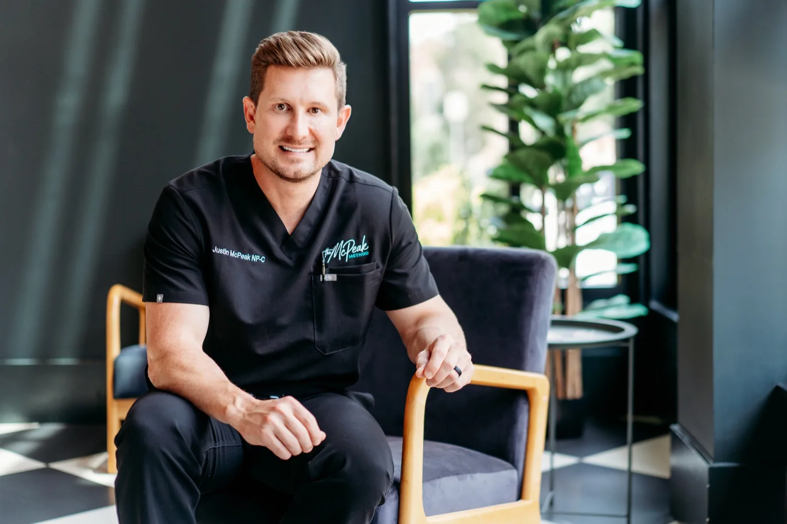 Justin McPeak in clinical scrubs